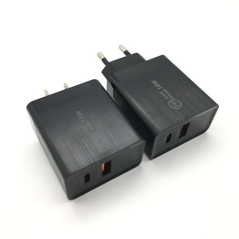White 18W USB-C fast wall charger with bare metal US plug prongs isolated on white background