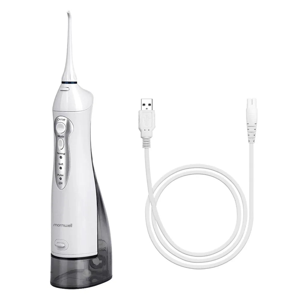 Portable white oral irrigator with large water tank, four nozzles, and a USB charging cable.