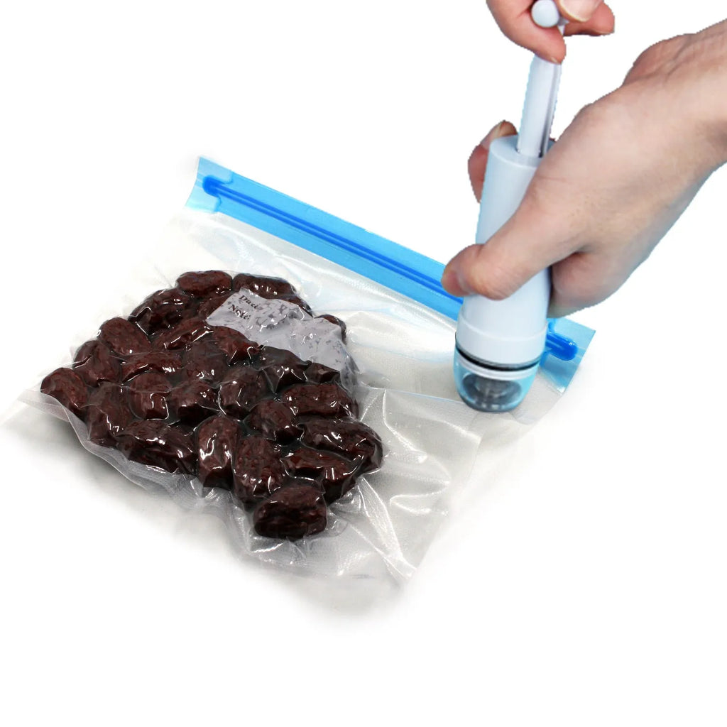 Green and grey manual vacuum compression storage bag with built-in valve and hand pump.