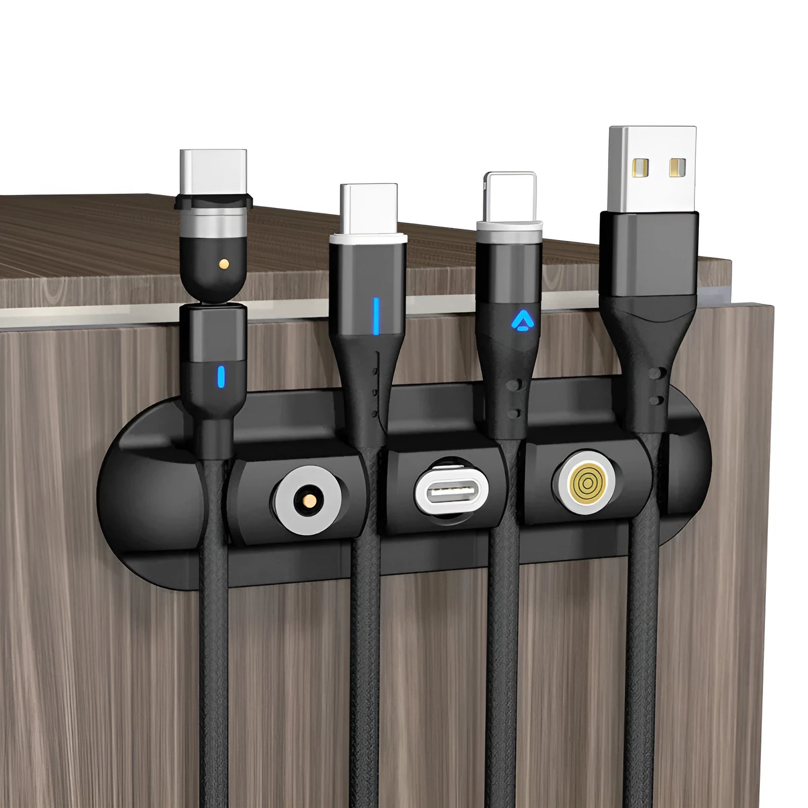 Black soft plastic desktop magnetic data cable organiser on a desk.