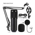 Bm800 condenser microphone kit with shock mount bracket, large pop filter, and foam windscreen on a desk.