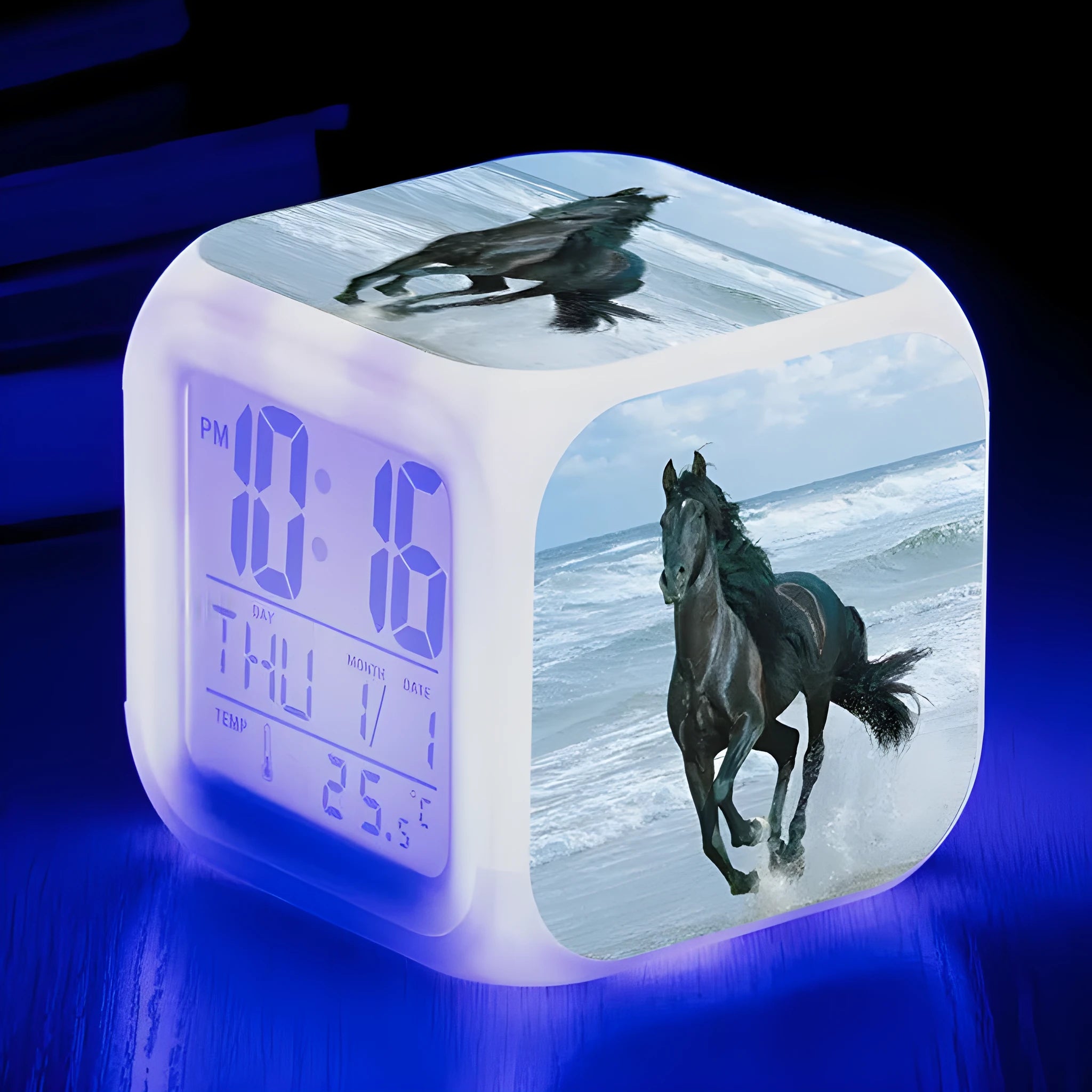 Small square cartoon LED alarm clock with colour-changing face showing digital time and temperature.