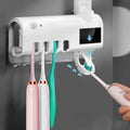 Black wall-mounted UV toothbrush steriliser with automatic toothpaste squeezer and solar panel