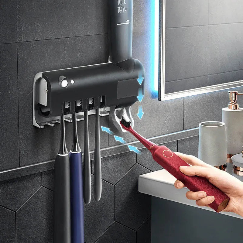 Black wall-mounted UV toothbrush steriliser with automatic toothpaste squeezer and solar panel