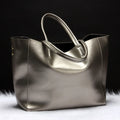 Women's cowhide leather shoulder bag in bronze colour with a detachable strap, shown with dimensions 34cm long by 31cm high.
