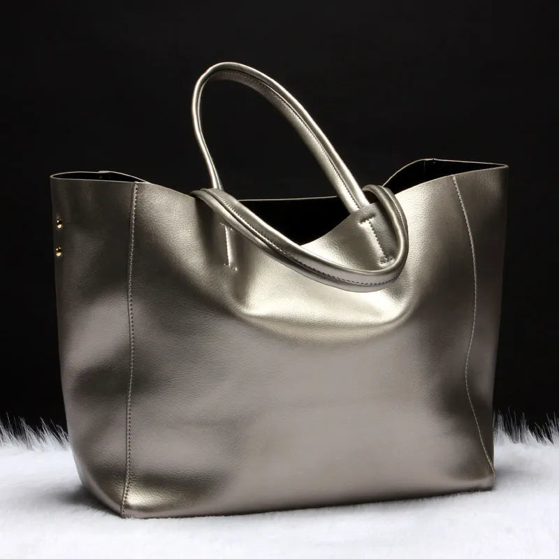 Women's cowhide leather shoulder bag in bronze colour with a detachable strap, shown with dimensions 34cm long by 31cm high.
