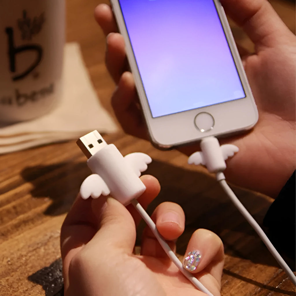 White angel and black bat style silicone protective covers for mobile phone charging cables.