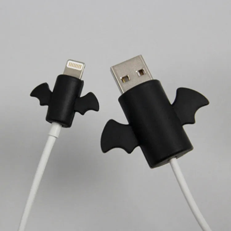 White angel and black bat style silicone protective covers for mobile phone charging cables.