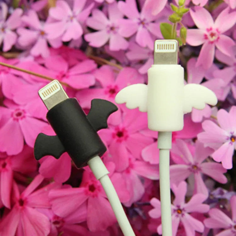 White angel and black bat style silicone protective covers for mobile phone charging cables.