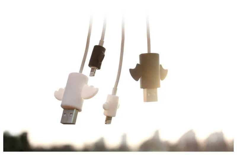 White angel and black bat style silicone protective covers for mobile phone charging cables.