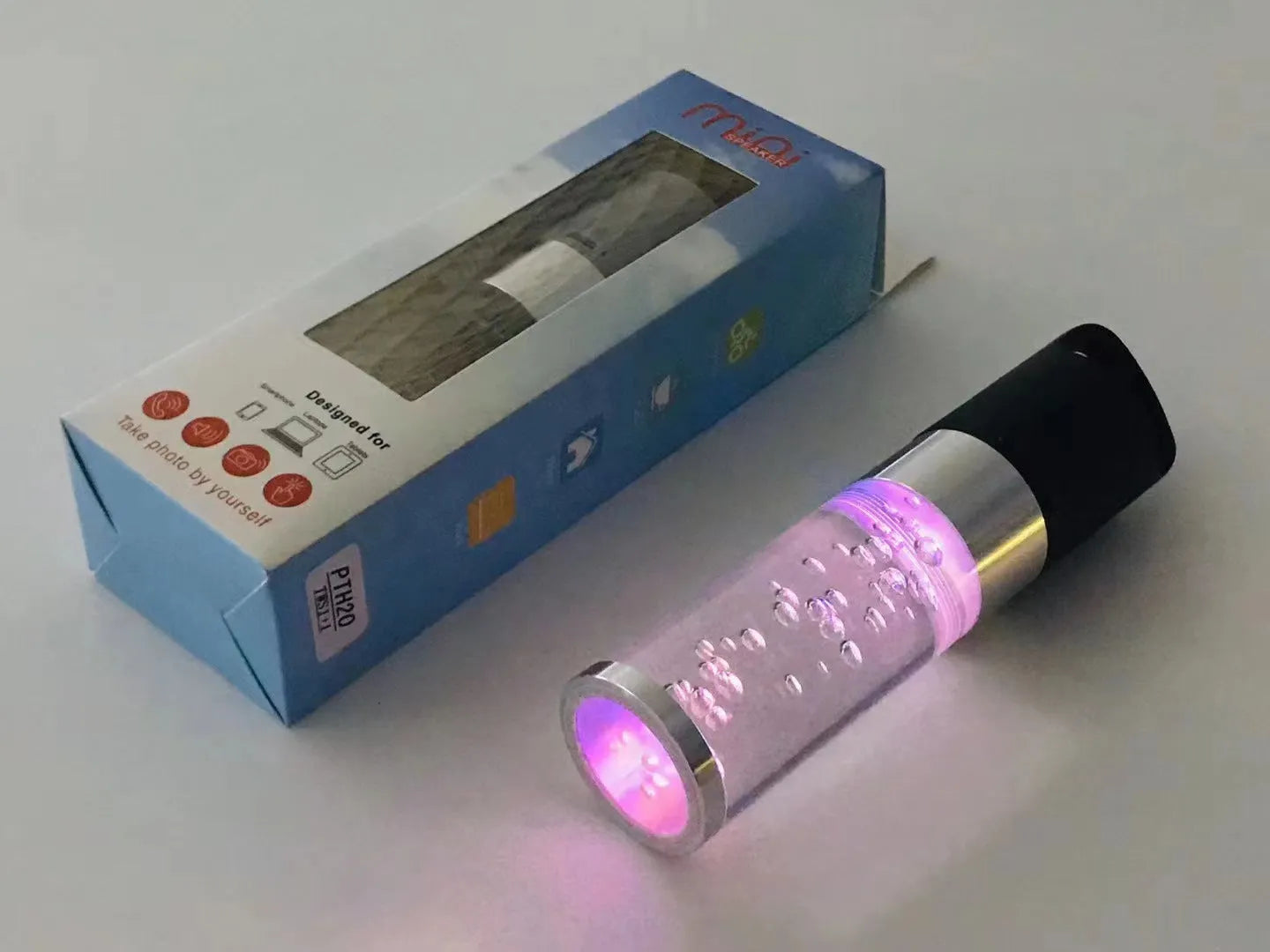 Compact rectangular Bluetooth speaker with crystal-effect LED lighting in pink colour, showing dimensions.