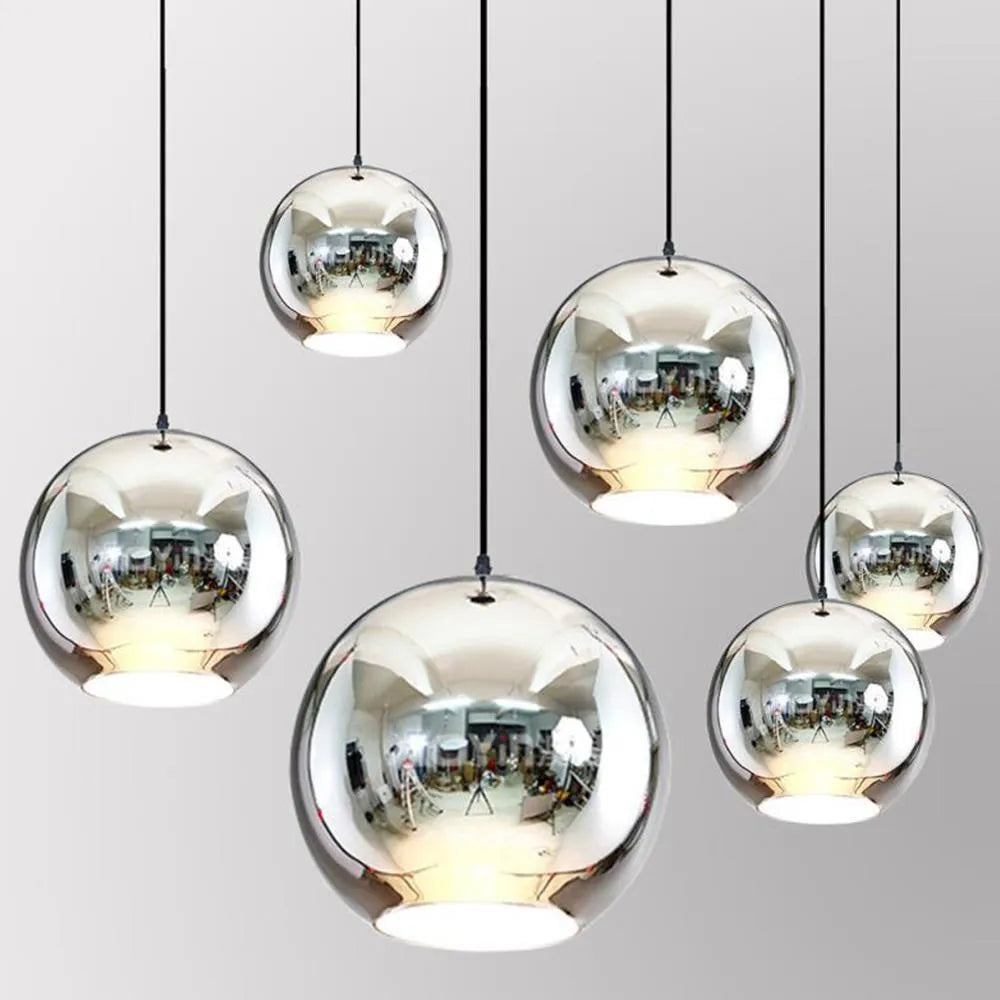 Round clear glass pendant chandelier with electroplated metal frame hanging on a thin wire