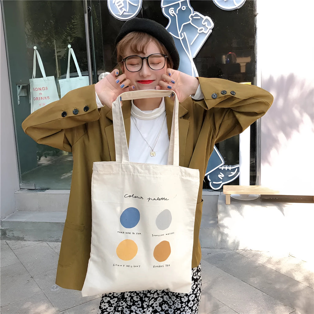 Medium orange canvas tote bag with geometric print, showing zipper opening and internal phone pocket.