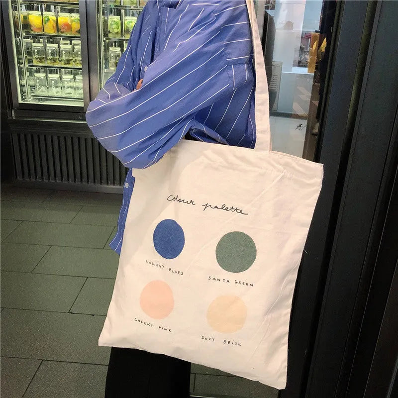 Medium orange canvas tote bag with geometric print, showing zipper opening and internal phone pocket.