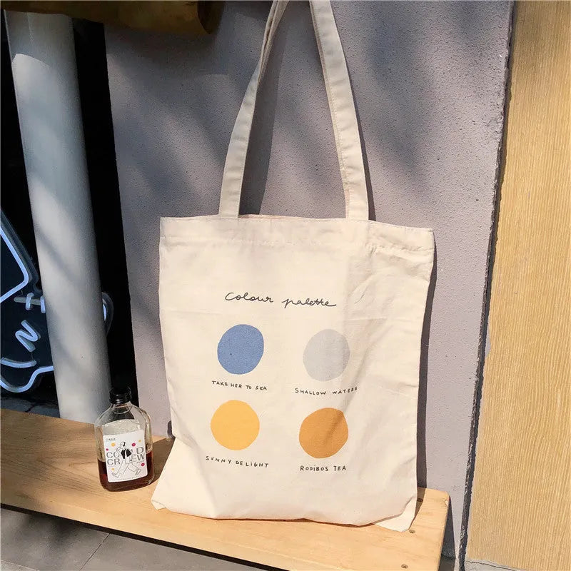 Medium orange canvas tote bag with geometric print, showing zipper opening and internal phone pocket.