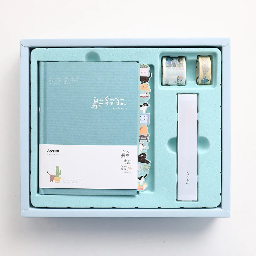 Peekaboo gift box containing a 13x18 cm hand ledger notebook and a pen, with a paper cover in a random colour.