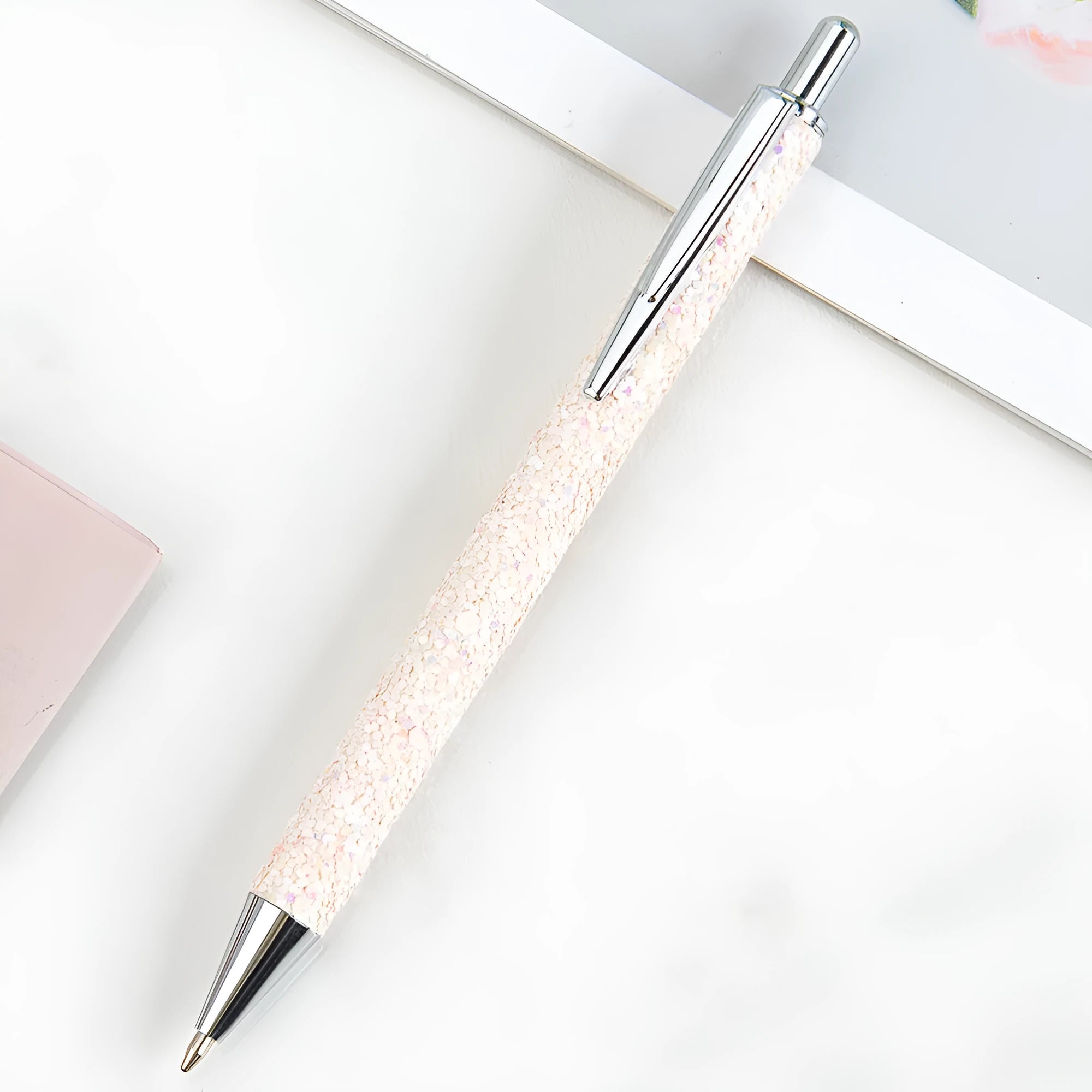 Metal push ballpoint pen with sequin finish in black colour on white background