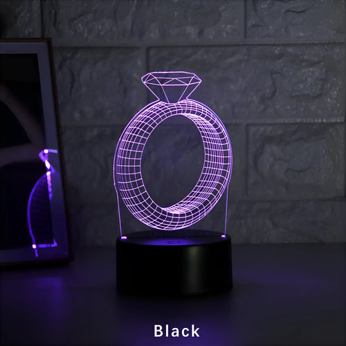 3D LED night light projecting a colourful diamond ring stereogram on a black base with touch control.