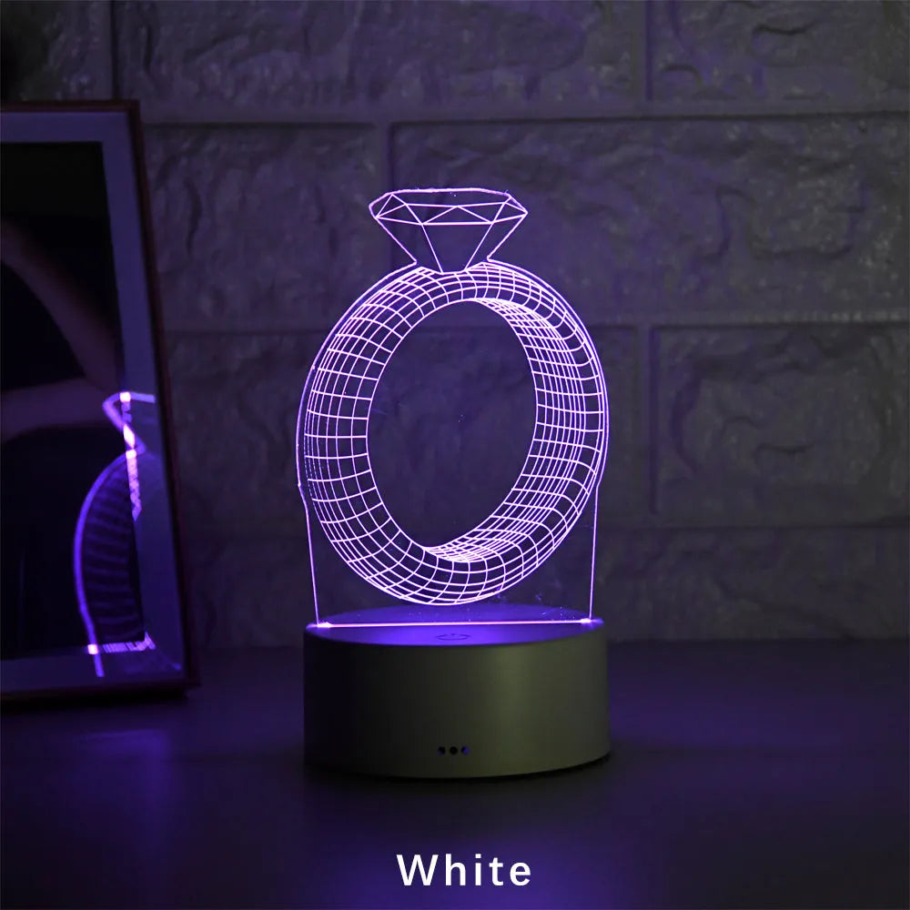 3D LED night light projecting a colourful diamond ring stereogram on a black base with touch control.
