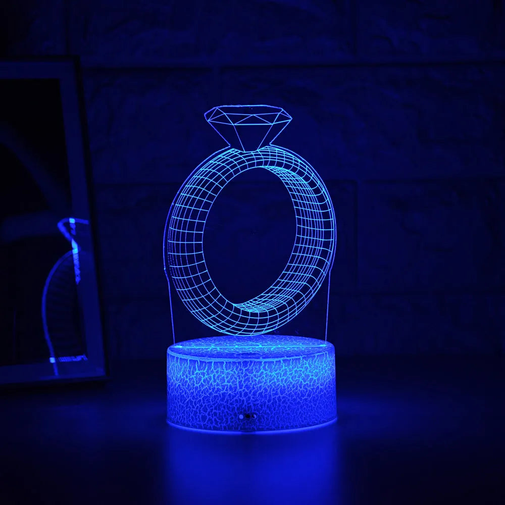 3D LED night light projecting a colourful diamond ring stereogram on a black base with touch control.