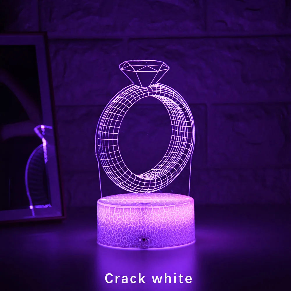 3D LED night light projecting a colourful diamond ring stereogram on a black base with touch control.