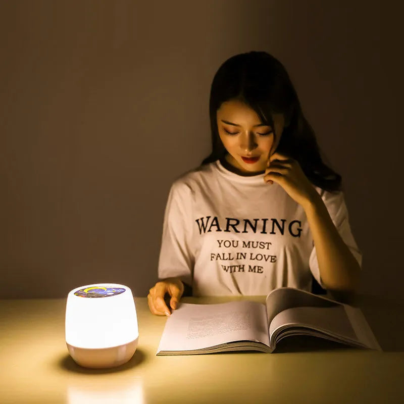 Pruixin rotating LED projector night light displaying star and moon patterns on a wall.