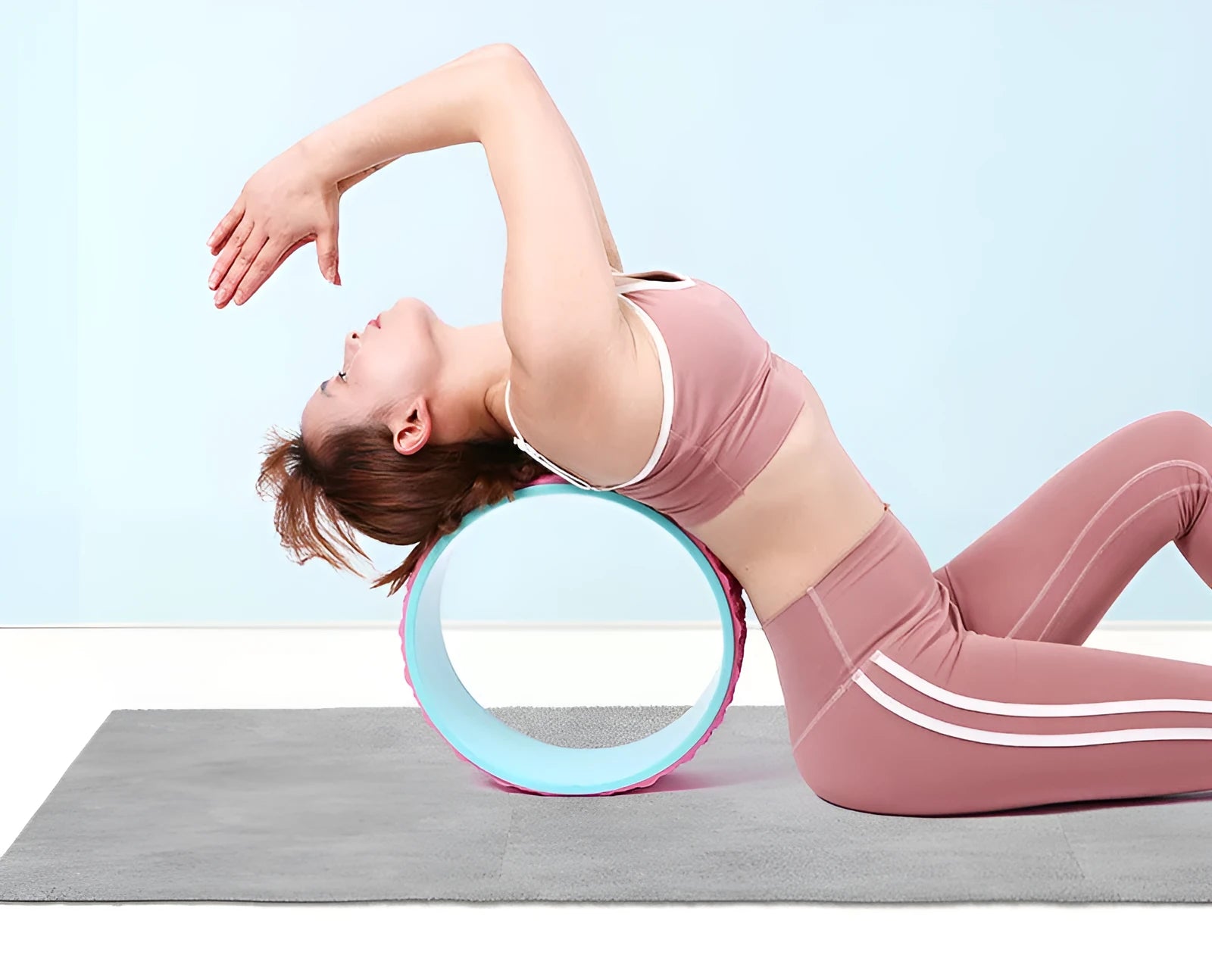 Massage point yoga wheel in black on floor with raised texture surface for backbending and Pilates muscle relaxation