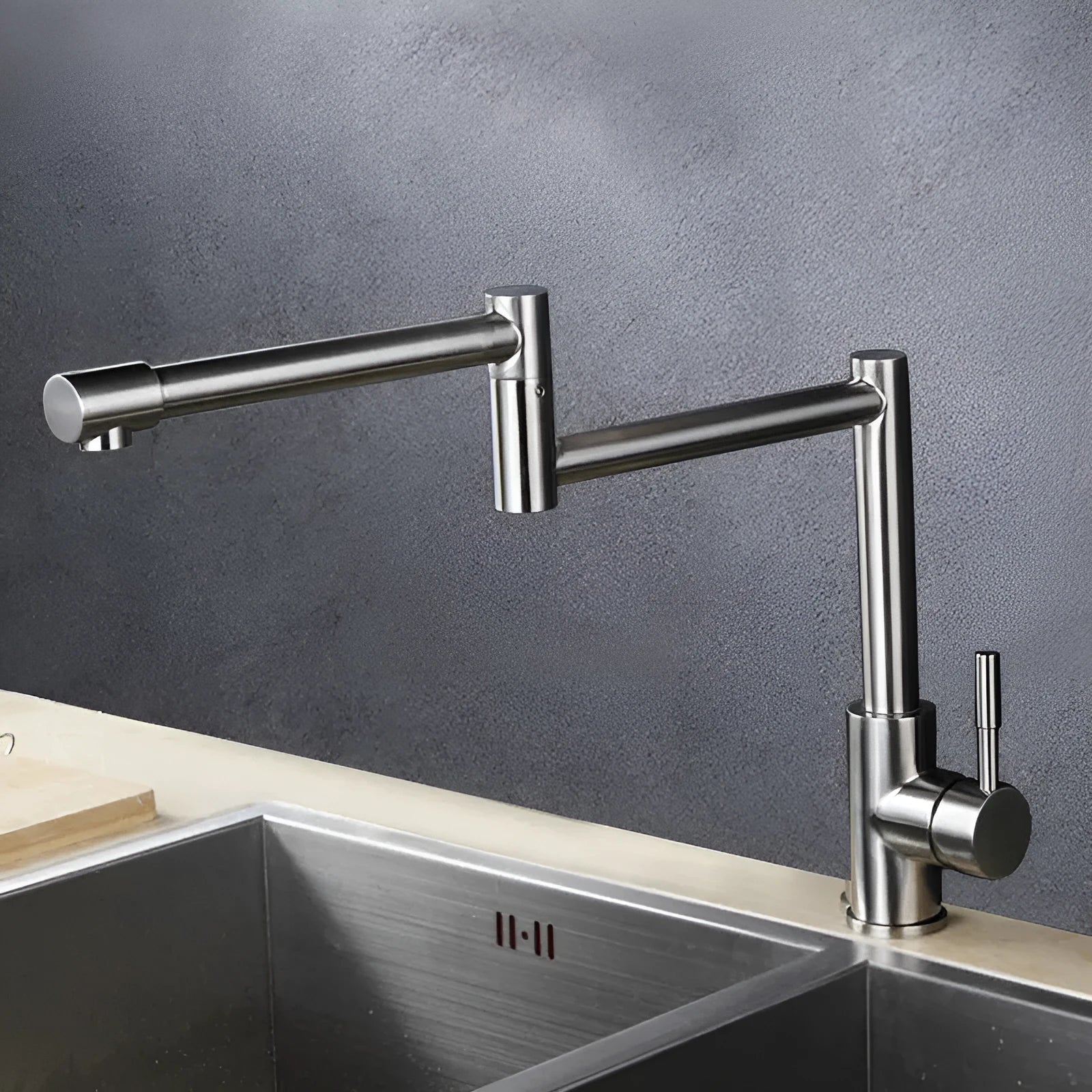 Silver stainless steel kitchen mixing tap with rotating spout and dual hot cold controls