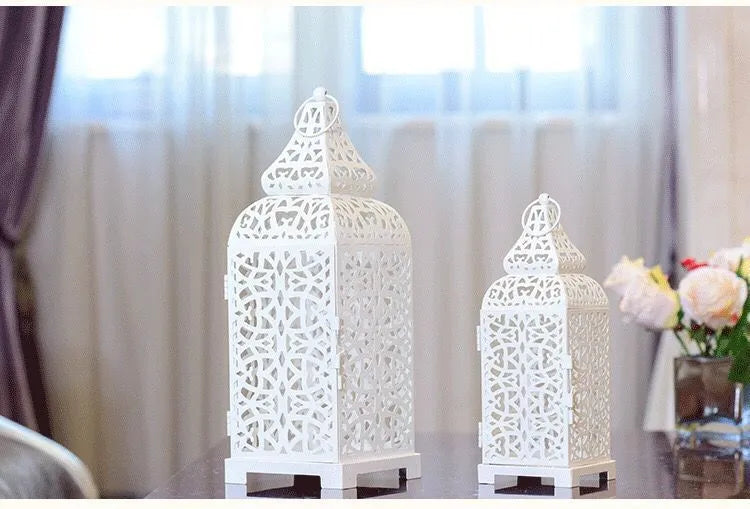 Pair of blue geometric metal wall sconces with tea light, showing Moroccan-style openwork design.