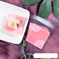 Pink self-adhesive plastic packaging bags with a 3cm flap, shown sealed and open, for handmade soap.