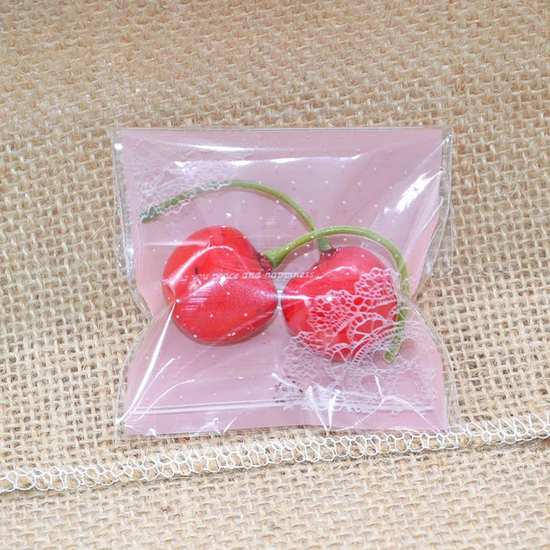 Pink self-adhesive plastic packaging bags with a 3cm flap, shown sealed and open, for handmade soap.