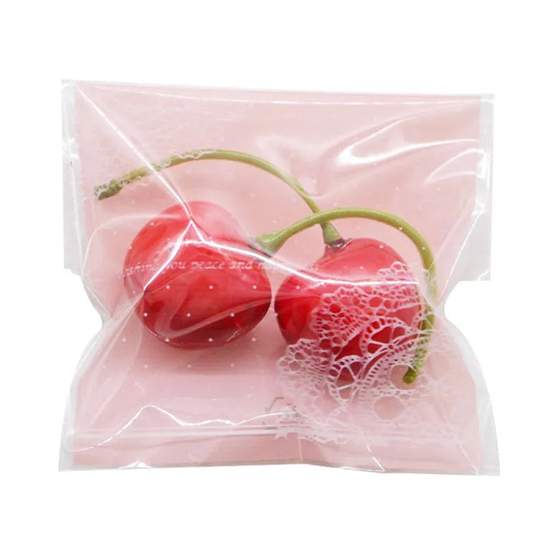Pink self-adhesive plastic packaging bags with a 3cm flap, shown sealed and open, for handmade soap.