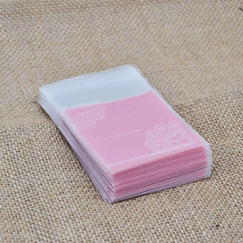 Pink self-adhesive plastic packaging bags with a 3cm flap, shown sealed and open, for handmade soap.