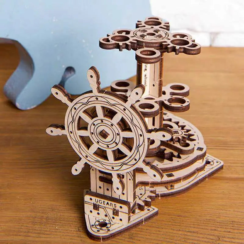 Ukrainian wooden rotating pen holder with steering wheel mechanism on a desk, holding coloured pencils