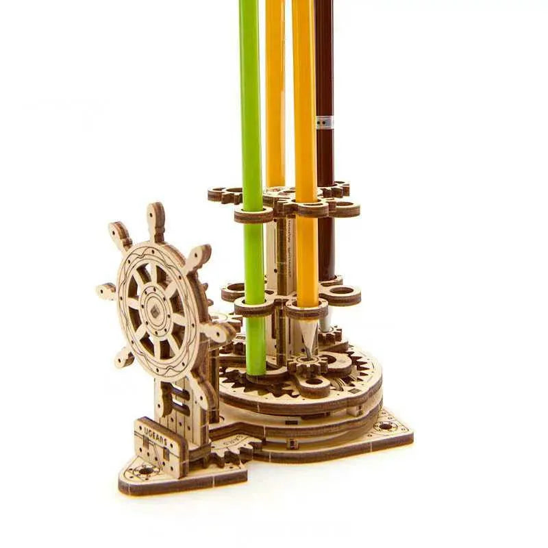 Ukrainian wooden rotating pen holder with steering wheel mechanism on a desk, holding coloured pencils