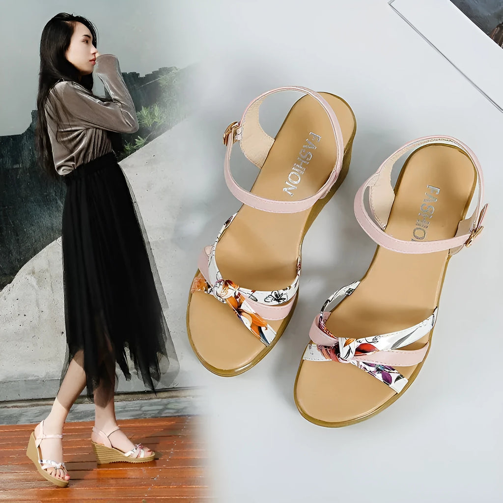 Women's pink wedge sandals with a thick heel and fish mouth design, featuring a buckle closure.