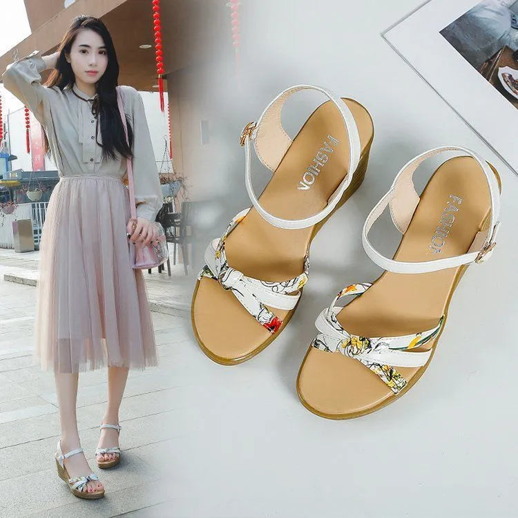 Women's pink wedge sandals with a thick heel and fish mouth design, featuring a buckle closure.