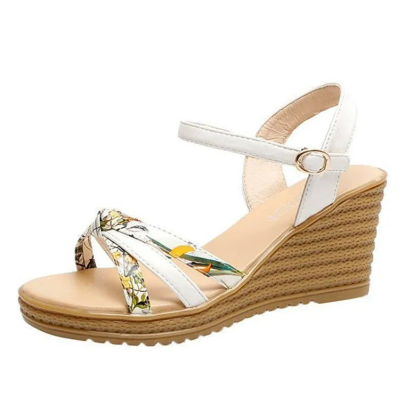 Women's pink wedge sandals with a thick heel and fish mouth design, featuring a buckle closure.