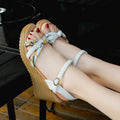 Women's pink wedge sandals with a thick heel and fish mouth design, featuring a buckle closure.