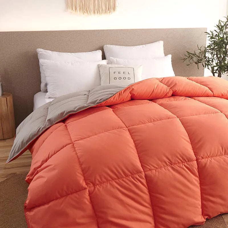 Goose down winter duvet in pink colour on a bed, showing twill weave fabric texture.