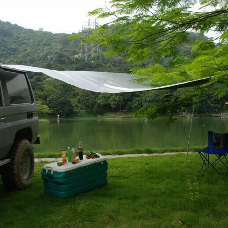 Green double tent car side awning with aluminium pole setup outdoors
