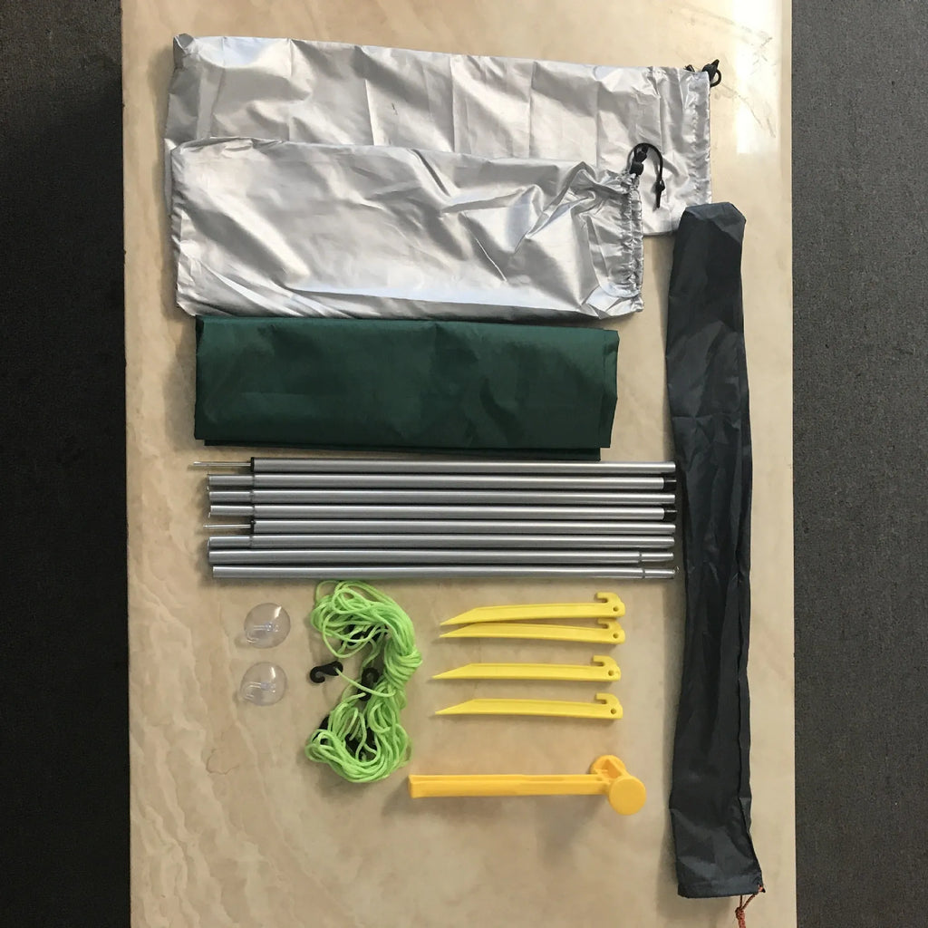 Green double tent car side awning with aluminium pole setup outdoors