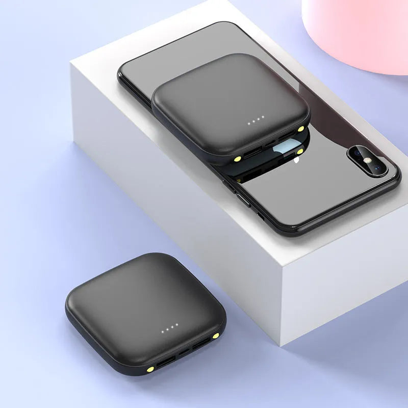 Black mini square power bank with LED flashlight, showing size scale