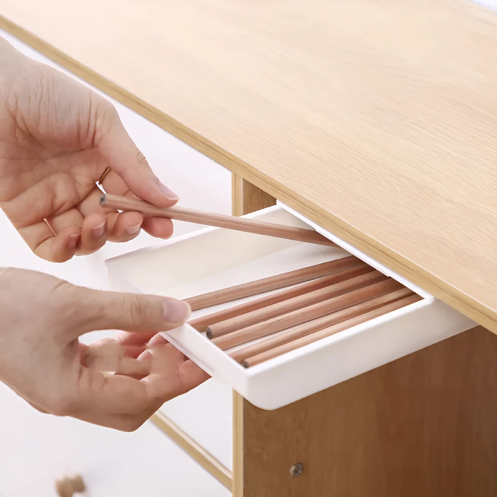 Grey plastic under-table drawer storage box for stationery, shown mounted underneath a wooden desk.