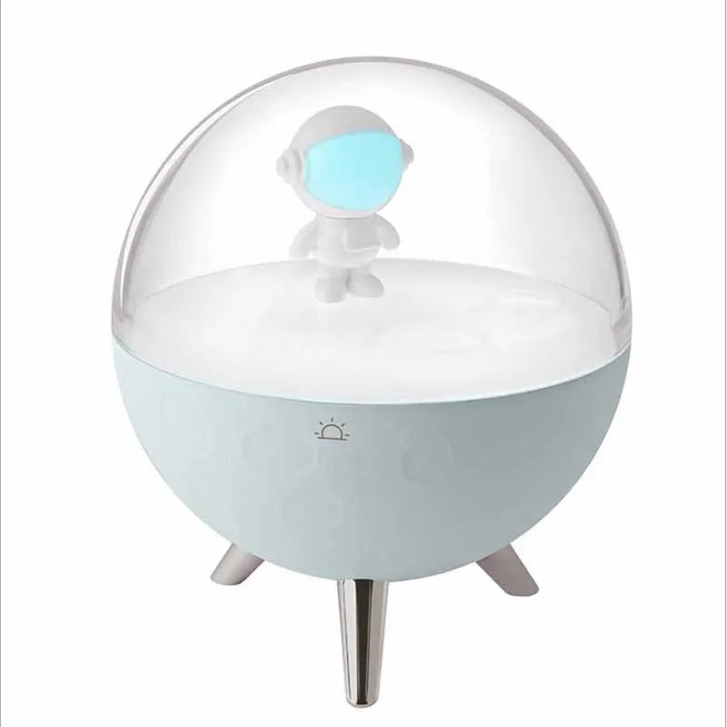 USB-powered cartoon-style LED night light showing white and blue colour options on a desk.