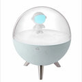 USB-powered cartoon-style LED night light showing white and blue colour options on a desk.