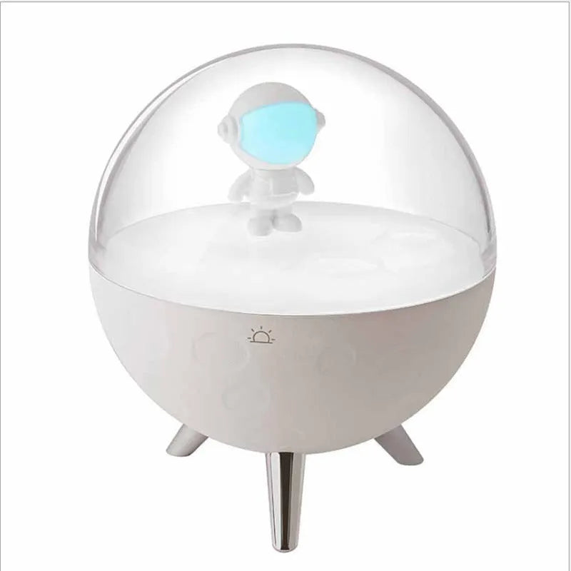 USB-powered cartoon-style LED night light showing white and blue colour options on a desk.