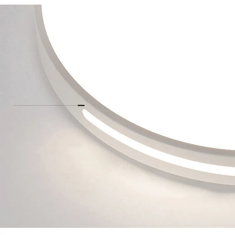 Round white acrylic remote control LED ceiling lamp mounted on a bedroom ceiling.