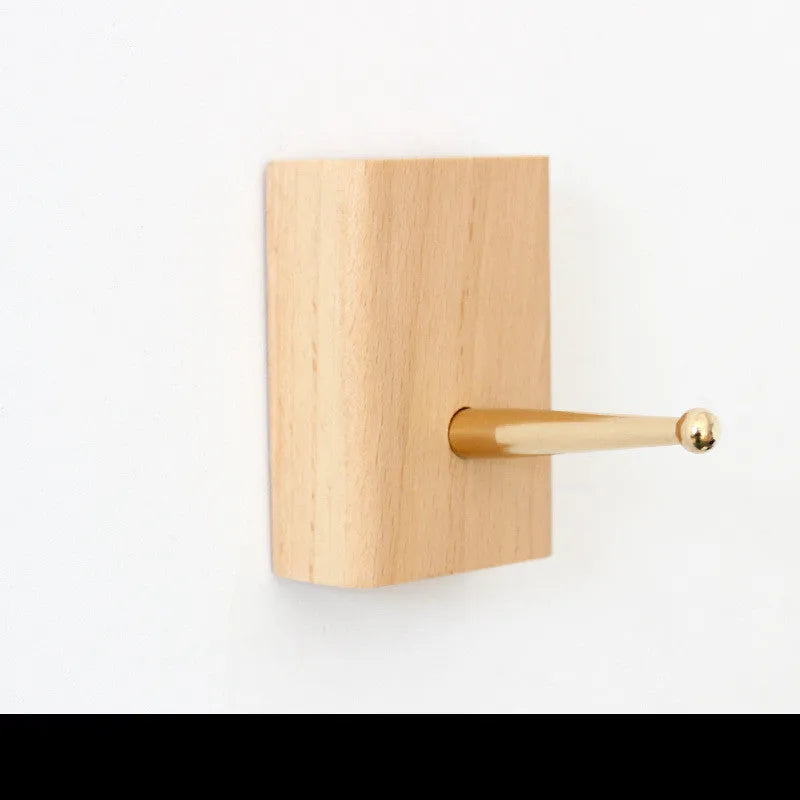 Beech wood wall hook with brass mechanism in five shapes: round, capsule, oval, diamond, and square