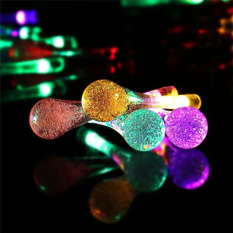 String of solar-powered LED garden lights with water drop-shaped pendants on a 6.5 metre cable.